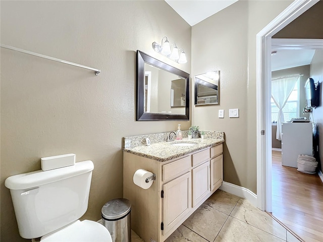 bathroom with hardwood / wood-style floors, vanity, and toilet