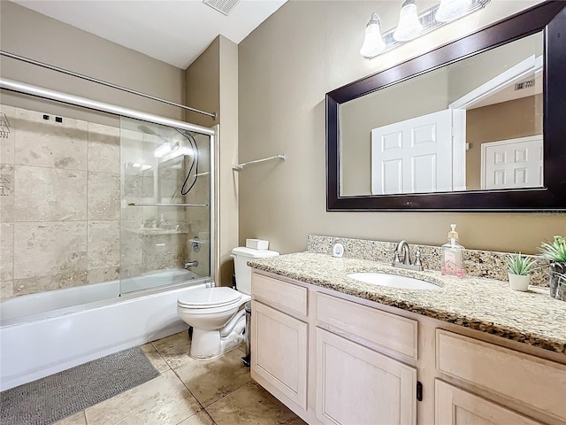 full bathroom featuring tile patterned flooring, vanity, enclosed tub / shower combo, and toilet