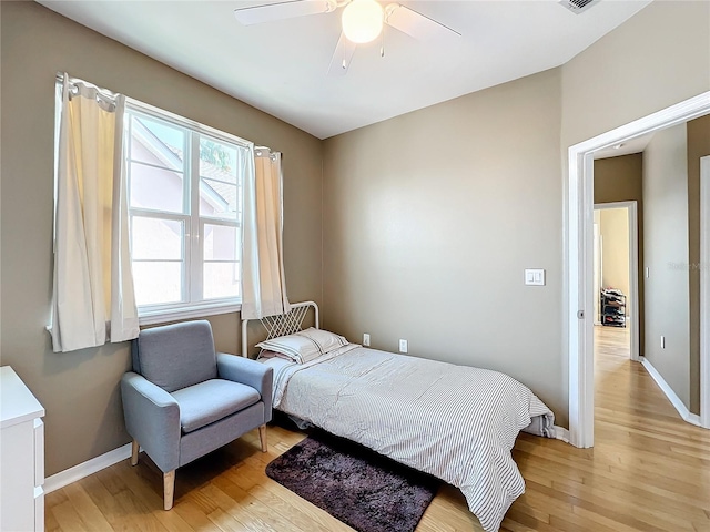 bedroom with ceiling fan and light wood-type flooring