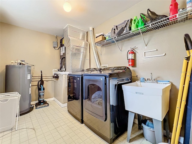 laundry area featuring independent washer and dryer, sink, and water heater