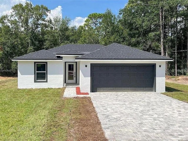 13435 Kaplan Ter, Port Charlotte, FL 33981 - view of front of house featuring stucco siding, a front lawn, a garage, decorative driveway, and a shingled roof
