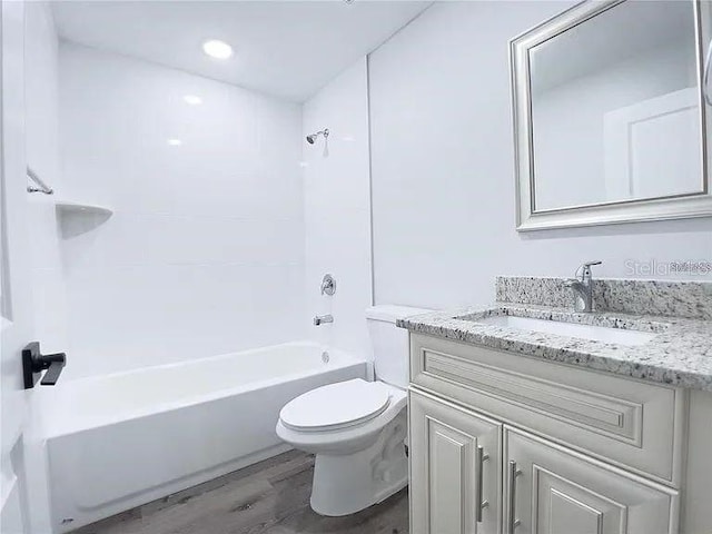 full bathroom featuring shower / bathtub combination, hardwood / wood-style flooring, vanity, and toilet