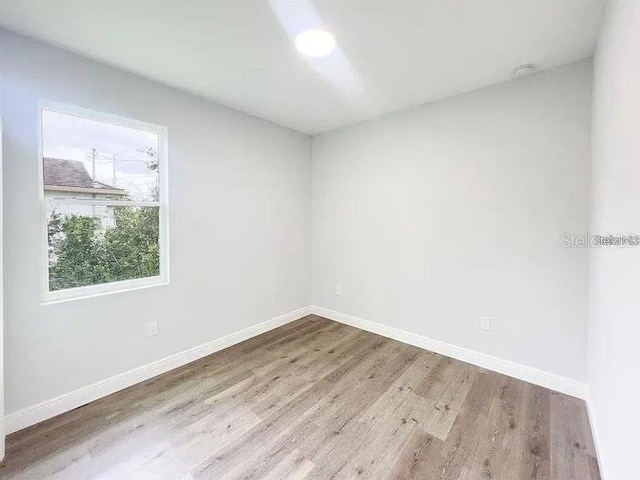 unfurnished room with hardwood / wood-style floors