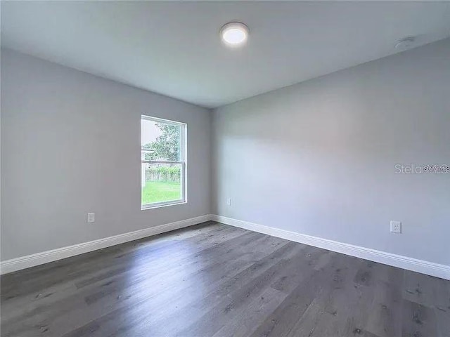 spare room featuring dark hardwood / wood-style floors