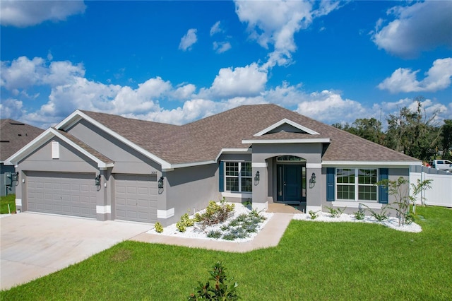 view of front of property featuring a front yard and a garage