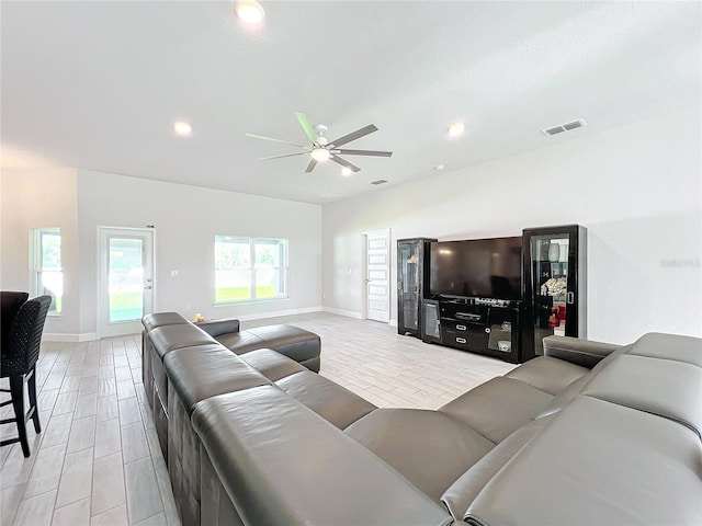 living room featuring light hardwood / wood-style floors and ceiling fan