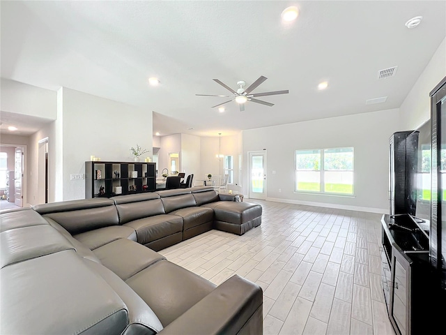 living room with ceiling fan and light wood-type flooring