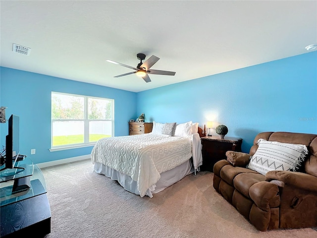 bedroom featuring ceiling fan and light carpet