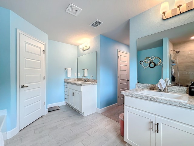 bathroom with vanity, walk in shower, and wood-type flooring