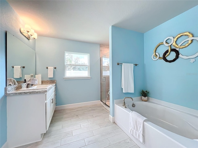 bathroom featuring vanity, plus walk in shower, and wood-type flooring