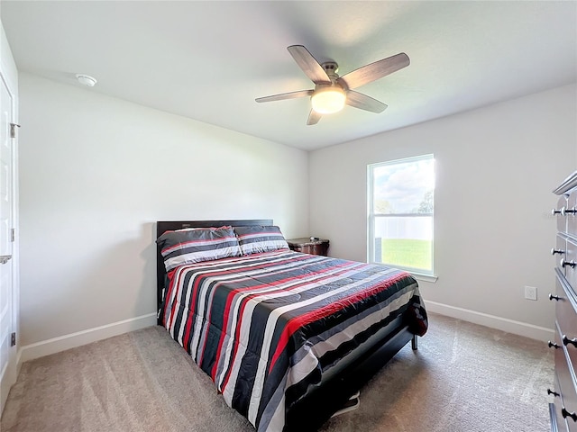 bedroom featuring light carpet and ceiling fan