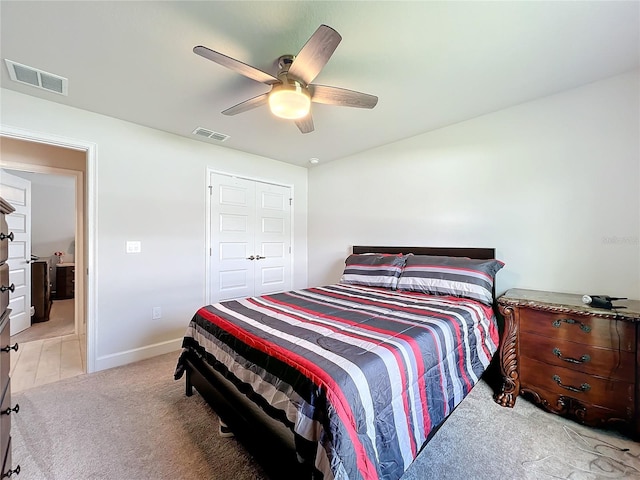 carpeted bedroom with a closet and ceiling fan