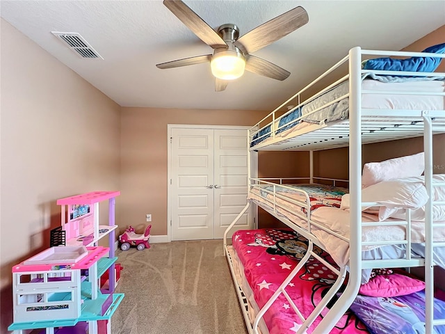 carpeted bedroom with a closet and ceiling fan