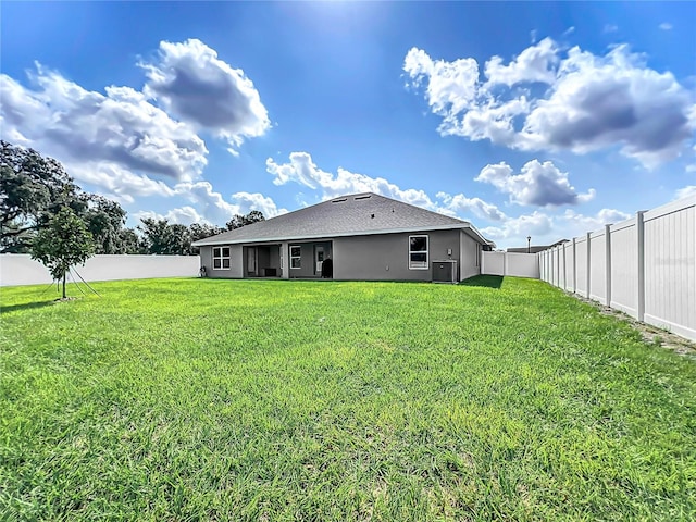 rear view of property with a lawn