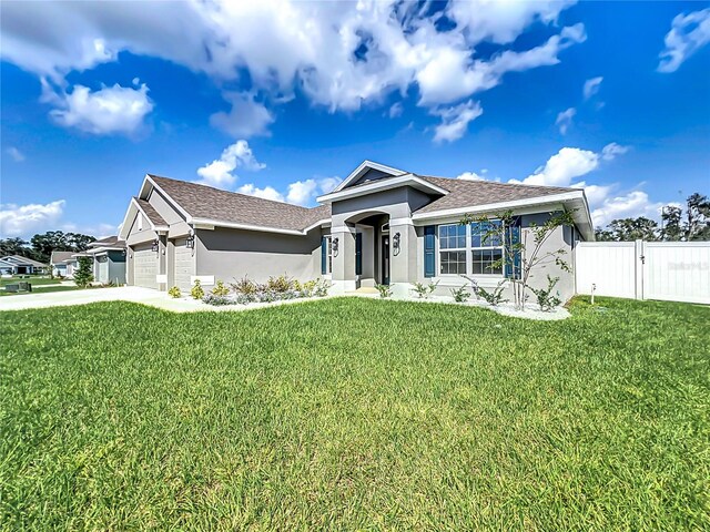 view of front of property with a garage and a front lawn