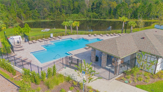 view of pool featuring a patio and a water view