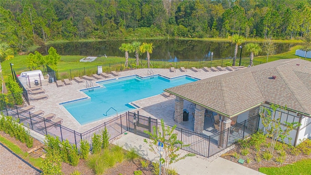 view of pool with a patio area and a water view