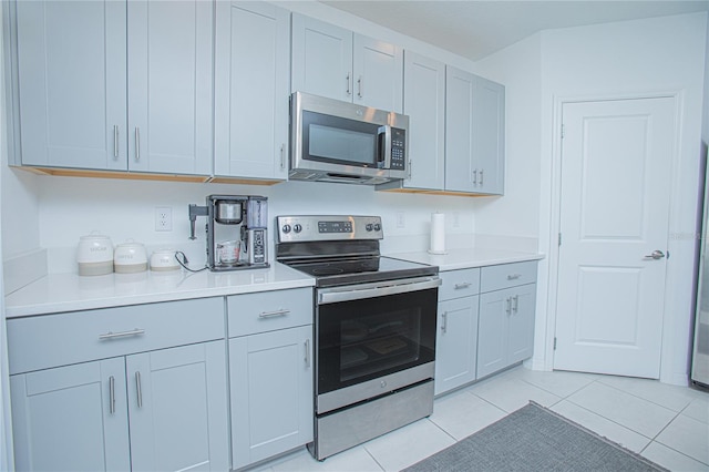 kitchen with appliances with stainless steel finishes and light tile patterned floors