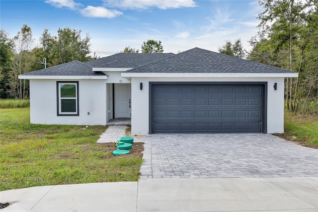 view of front of property with a front yard and a garage