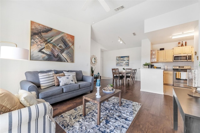 living room with lofted ceiling, dark wood-type flooring, and ceiling fan