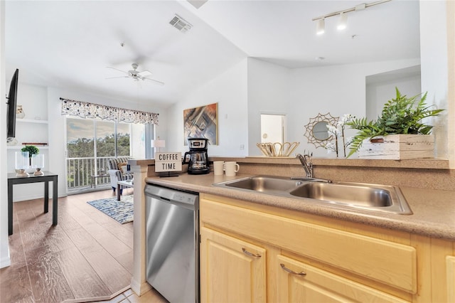 kitchen with dishwasher, vaulted ceiling, ceiling fan, light brown cabinetry, and sink