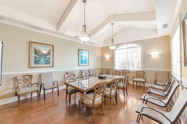 dining area featuring vaulted ceiling, crown molding, and wood-type flooring