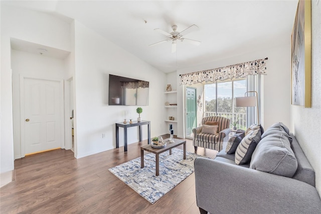 living room featuring vaulted ceiling, built in shelves, ceiling fan, and dark hardwood / wood-style flooring