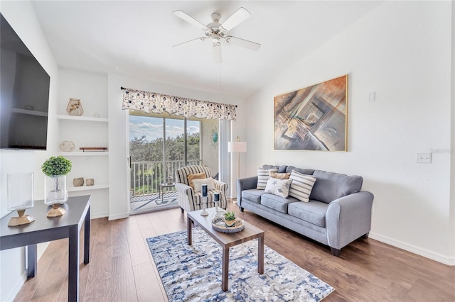 living room featuring ceiling fan, hardwood / wood-style floors, and built in features