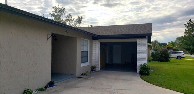 view of side of home with a lawn