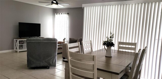 dining room with ceiling fan and light tile patterned flooring