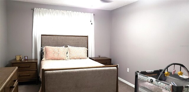 bedroom featuring dark carpet