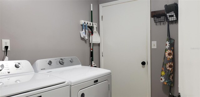 washroom with washing machine and clothes dryer