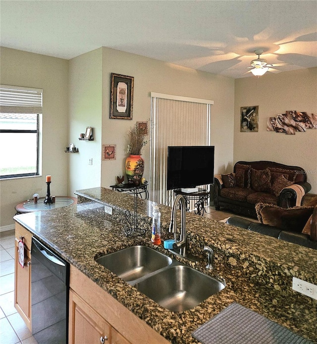 kitchen with black dishwasher, sink, ceiling fan, light tile patterned floors, and light brown cabinets