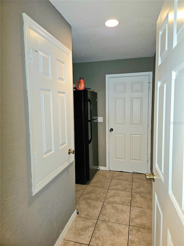 corridor with light tile patterned flooring