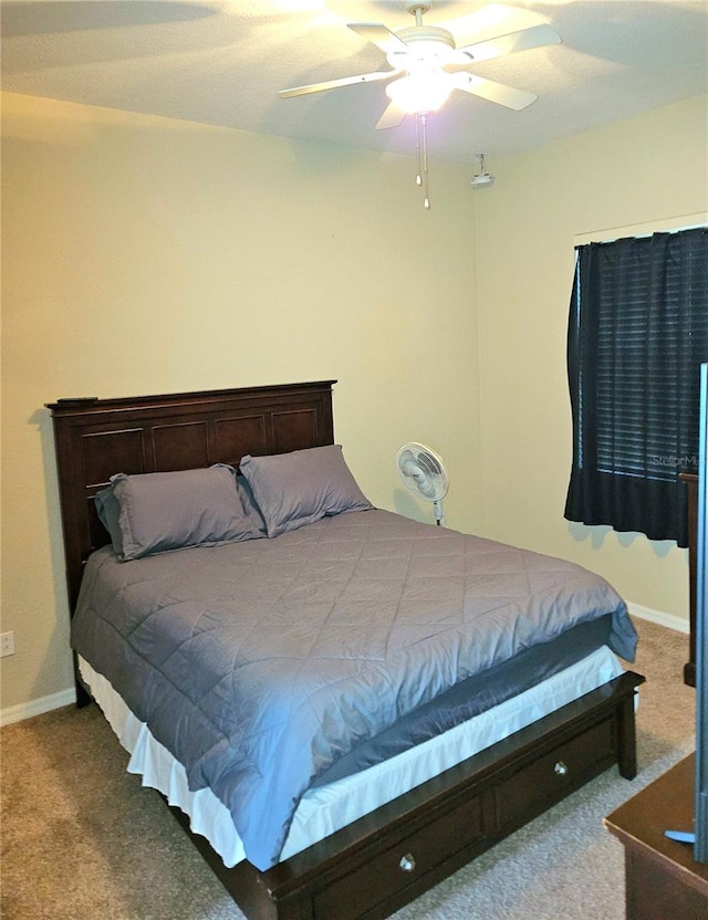 bedroom with ceiling fan and carpet flooring