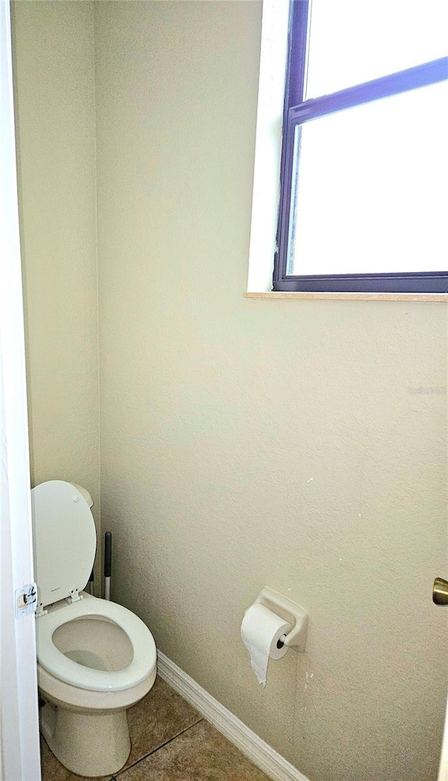 bathroom with tile patterned floors and toilet