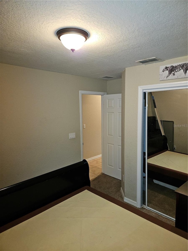 unfurnished bedroom featuring a closet and a textured ceiling