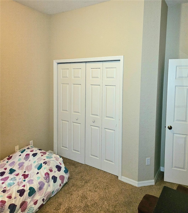 bedroom with a closet and carpet floors