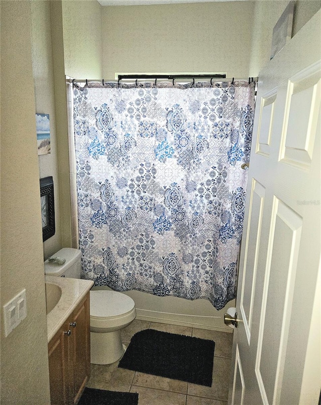 full bathroom with vanity, shower / bath combo with shower curtain, toilet, and tile patterned floors