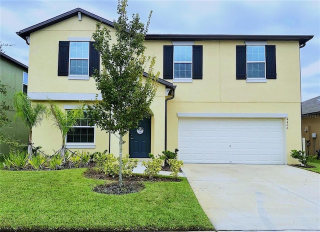 view of front of home featuring a front yard and a garage