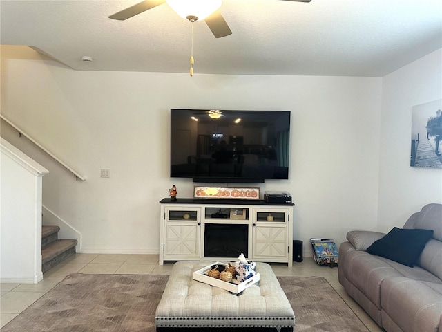 tiled living room featuring a textured ceiling and ceiling fan