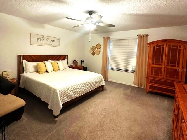 bedroom featuring carpet flooring, ceiling fan, and a textured ceiling