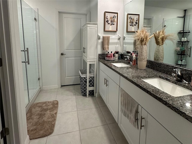 bathroom with tile patterned floors, vanity, and a shower with shower door