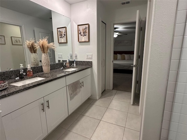 bathroom with tile patterned flooring, vanity, and ceiling fan