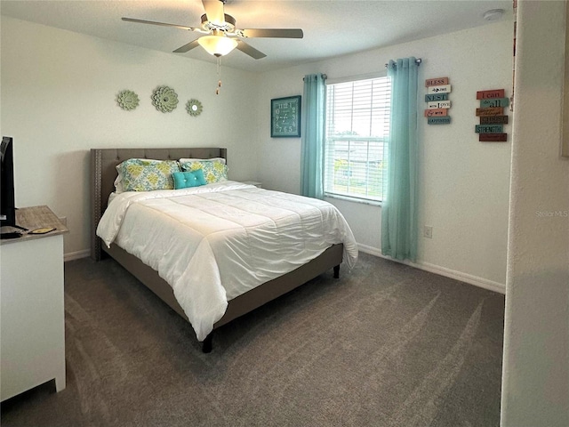 bedroom with ceiling fan and dark colored carpet