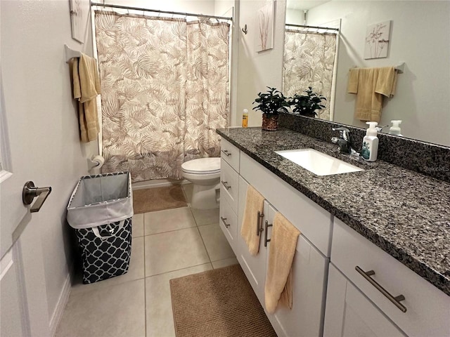 bathroom featuring tile patterned floors, vanity, and toilet