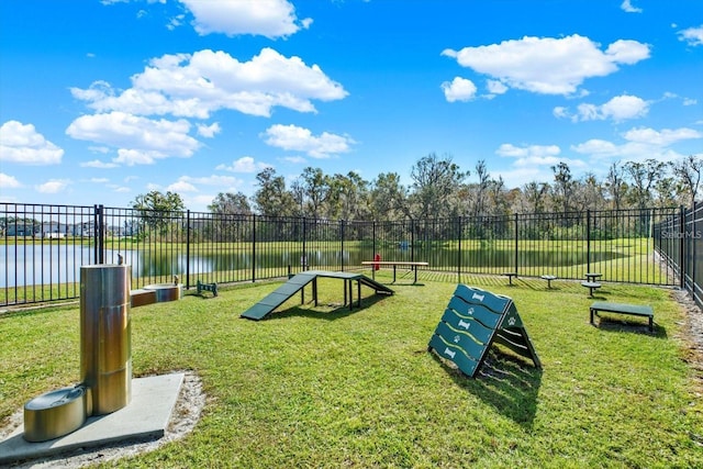 view of community with a water view and a yard