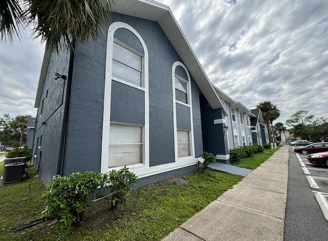view of home's exterior featuring stucco siding and central air condition unit