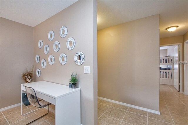 home office with baseboards and tile patterned floors