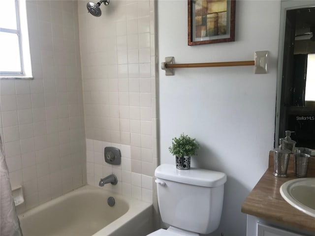 bathroom with shower / bath combo, toilet, and vanity